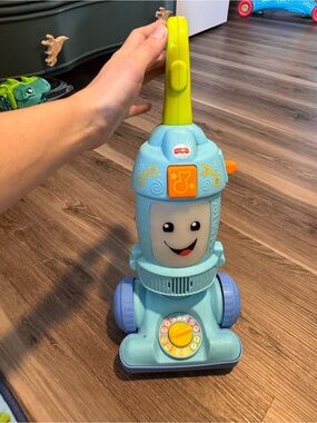 Fisher-Price Light Blue Toy Vacuum with Yellow-Green Handle and Purple Wheels